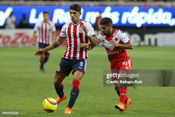 Alan Pulido of Chivas fights for the ball with Daniel Villalva of Veracruz during the 14th round match between Chivas and Veracruz as part of the...