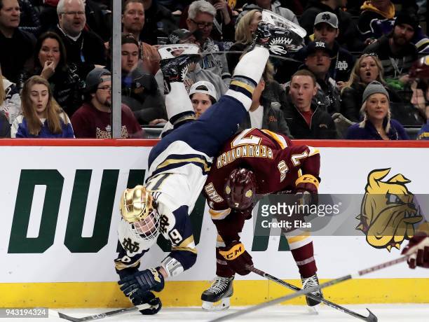 Mike O'Leary of the Notre Dame Fighting Irish flips over Scott Perunovich of the Minnesota-Duluth Bulldogs during the championship game of the 2018...