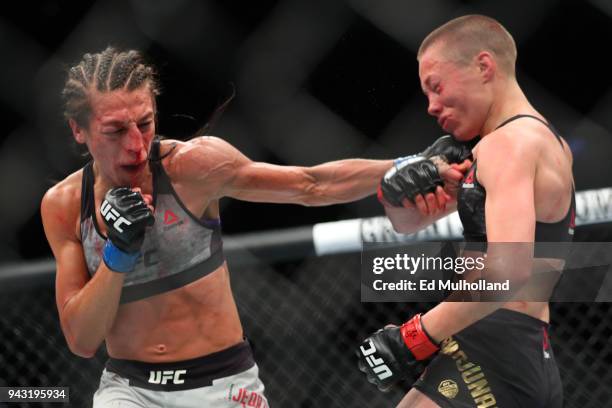 Joanna Jedrzejczyk lands a left hand to the head of UFC strawweight champion Rose Namajunas during their UFC women's strawweight championship bout at...