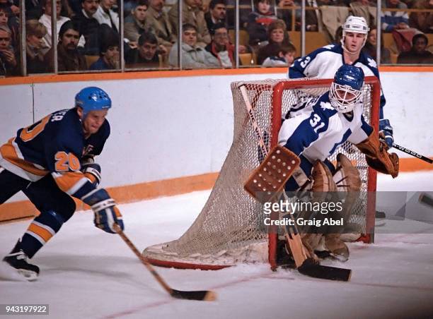 Ken Wregget and Al Iafrate of the Toronto Maple skate against Mark Hunter of the St. Louis Blues during game action on December 11, 1985 at Maple...