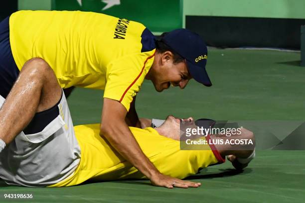 Colombian tennis player Alejandro Gonzalez celebrates with his teammate Pablo Gonzalez after defeating Brazilian tennis player Joao Sorgi during...
