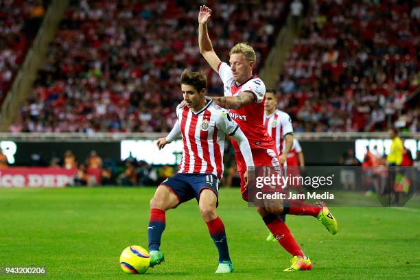 Isaac Brizuela of Chivas and Cristian Menendez of Veracruz during the 14th round match between Chivas and Veracruz as part of the Torneo Clausura...