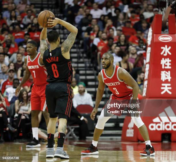 Chris Paul of the Houston Rockets defends Shabazz Napier of the Portland Trail Blazers in the second half at Toyota Center on April 5, 2018 in...