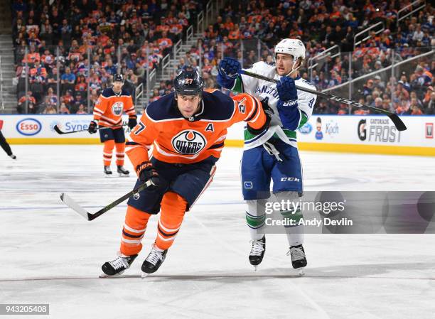 Milan Lucic of the Edmonton Oilers battles for the puck against Brendan Leipsic of the Vancouver Canucks on April 7, 2018 at Rogers Place in...