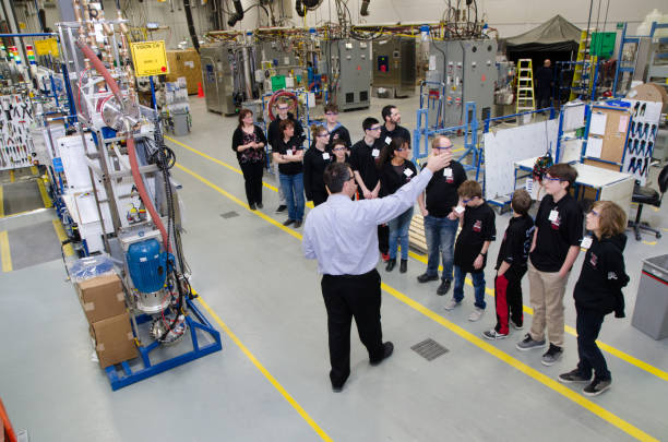 Tour group comprised of middle school aged youth and some teachers of a manufacturing facility.