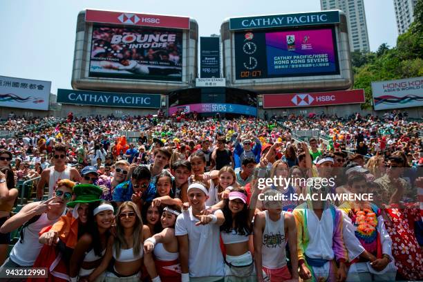 Fans attend the third day of the Hong Kong Sevens rugby tournament in Hong Kong on April 8, 2018. / AFP PHOTO / ISAAC LAWRENCE