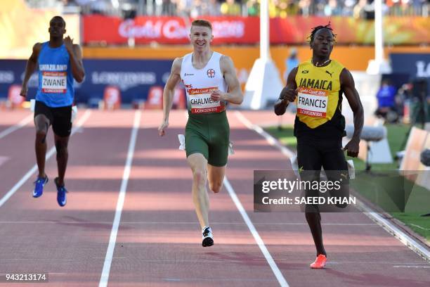 Jamaicas Javon Francis and Guernseys Cameron Chalmers compete in the athletic's men's 400m heats during the 2018 Gold Coast Commonwealth Games at the...