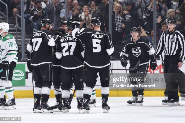 Jeff Carter, Alec Martinez, Christian Folin, and Kyle Clifford of the Los Angeles Kings celebrate after scoring a goal against the Dallas Stars at...