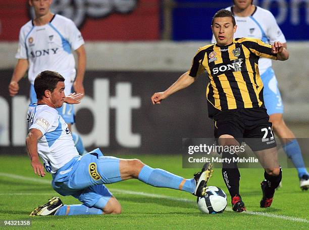 Costa Barbarouses of the Phoenix is tackled by Stuart Musialik of Sydney FC during the round 18 A-League match between the Wellington Phoenix and...