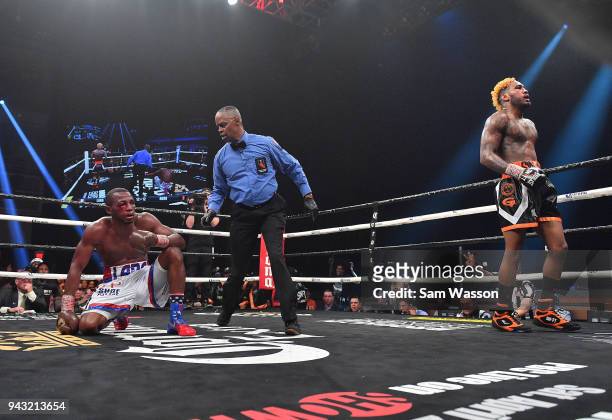 Referee Kenny Bayless delivers a count to Erislandy Lara as Jarrett Hurd heads to a neutral corner during their WBA/IBF junior middleweight...