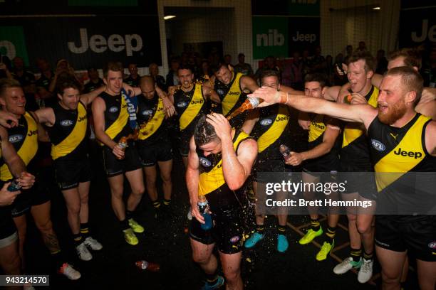 Jack Higgins of the Tigers celebrates with team mates after victory during the round three AFL match between the Richmond Tigers and the Hawthorn...