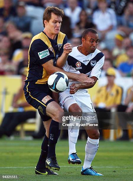 Archie Thompson of the Victory clashes with Neil Boogaard of the Mariners during the round 18 A-League match between the Central Coast Mariners and...