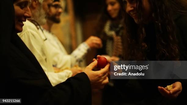 Orthodox Christians receives the antidoron sacrimental bread and a red dyed egg in celebration of the Orthodox Easter at Marko's Monastery near...