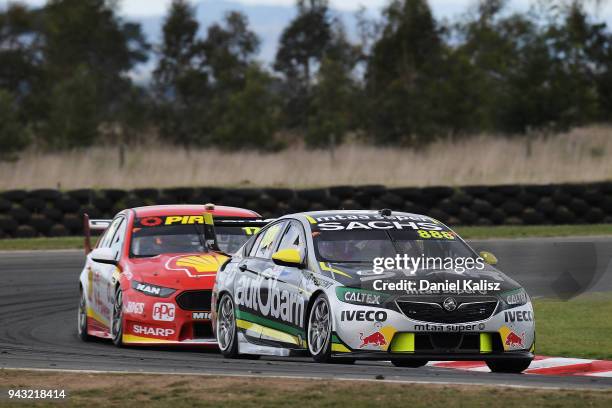 Craig Lowndes drives the Autobarn Lowndes Racing Holden Commodore ZB leads Scott McLaughlin drives the Shell V-Power Racing Team Ford Falcon FGX...