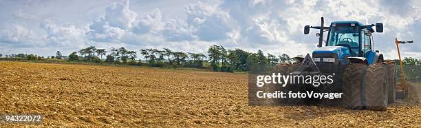 big tractor, golden earth - ploughed field stock pictures, royalty-free photos & images