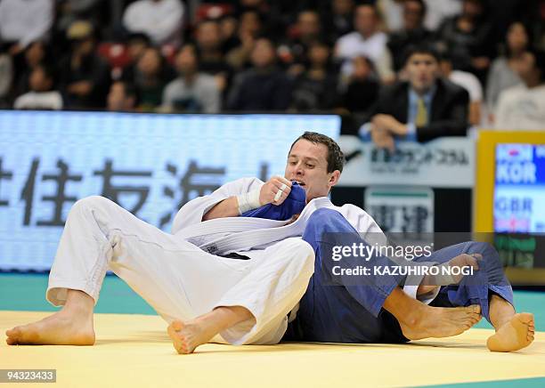 Britain's Euan Burton holds South Korea's Kim Jae-Bum in the men's -81kg class final match at the Grand Slam Tokyo judo tournament at Tokyo...