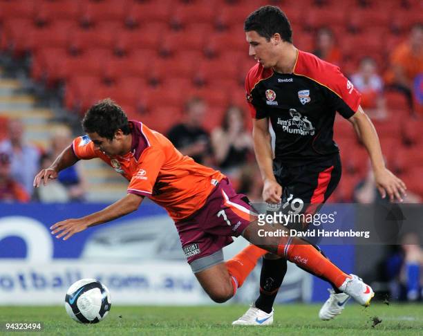 Michael Zulloo of the Roar and Mathew Leckie of United compete for the ball during the round 18 A-League match between the Brisbane Roar and Adelaide...
