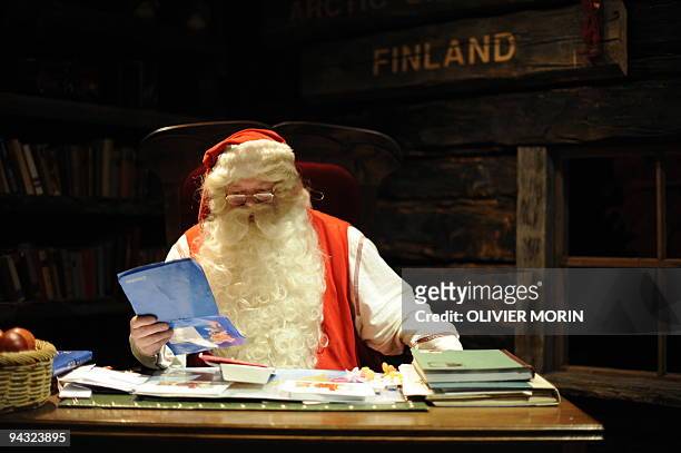 Santa Claus reads letters coming in from the world in his "office" in Rovaniemi, on December 16, 2008. Rovaniemi's Christmas theme park is in full...