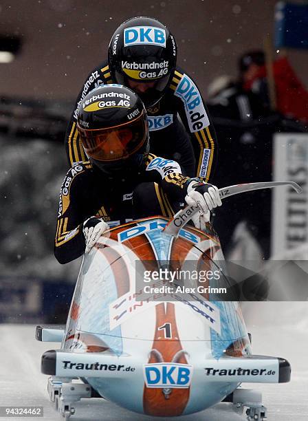 Pilot Sandra Kiriasis and Janine Tischer of Germany push off at the start in heat one of the women's bobsleigh competition during the FIBT Bob &...