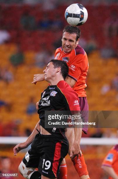 Josh McCloughan of the Roar and Mathew Leckie of United compete for the ball during the round 18 A-League match between the Brisbane Roar and...