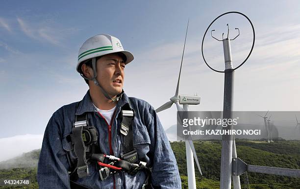 Japan-environment-climate-warming, by Patrice Novotny Ryo Nagasawa, a chief mechanic of wind-power farm Eurus Energy Japan Corp, works on top of a...