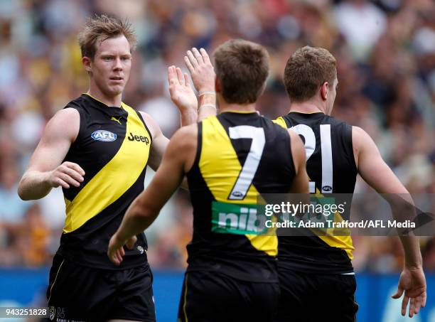 Jack Riewoldt of the Tigers celebrates a goal with teammates during the 2018 AFL round 03 match between the Richmond Tigers and the Hawthorn Hawks at...