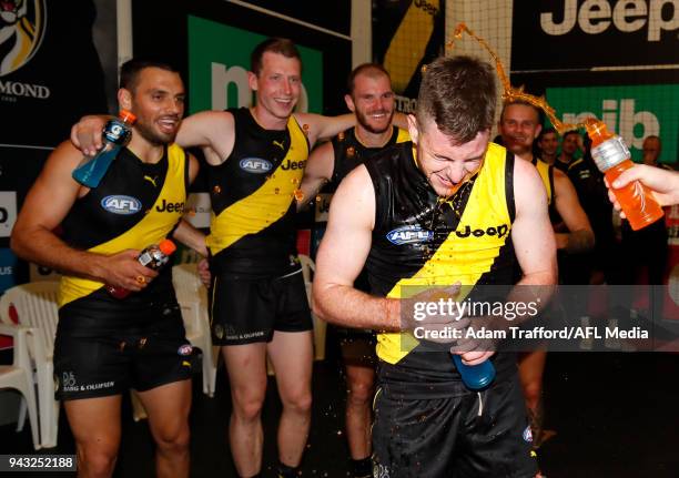 Debutant, Jack Higgins of the Tigers sings the team song after his first win during the 2018 AFL round 03 match between the Richmond Tigers and the...
