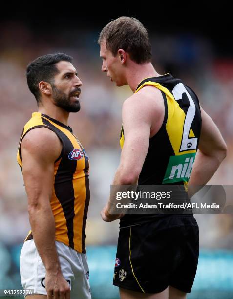 Paul Puopolo of the Hawks remonstrates with Dylan Grimes of the Tigers after kicking a goal from a free kick paid to him for a high tackle during the...