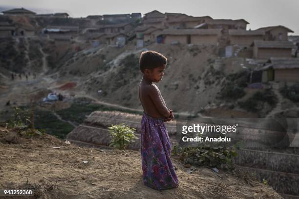 Rohingya kid looks on from the top of shelters at Kutupalong refugee camp in Maynar Guna, near Cox's Bazar, Bangladesh on April 07, 2018. Rohingya...