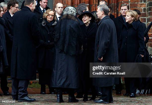 German Chancellor Angela Merkel and German Foreign Minister Guido Westerwelle waits as German President Horst Koehlers wife Eva-Luise Koehler offer...