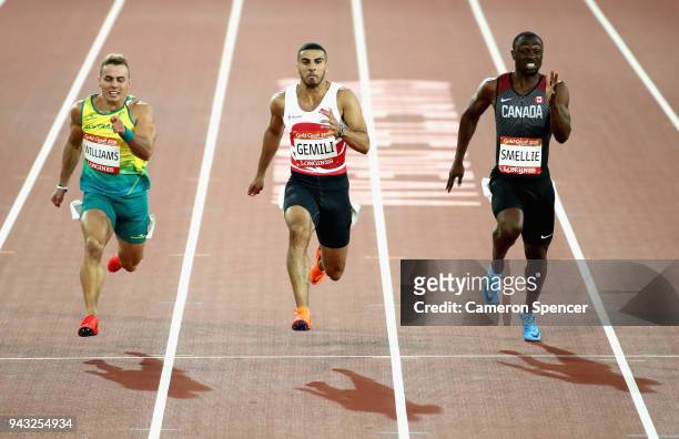 Trae Williams of Australia, Adam Gemili of England and Gavin Smellie of Canada compete in the Men's 100 metres semi finals on day four of the Gold...