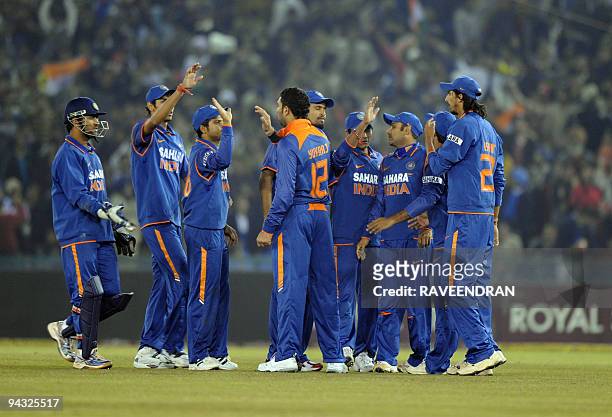 Indian cricketers celebrate the wicket of Sri Lankan batsman Tillakaraine Dilshan during the second Twenty20 International match between India and...