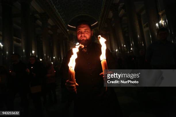 Believers with the Holy fire brought from Jerusalem to Kazan Cathedral in St. Petersburg, Russia 08 april 2018
