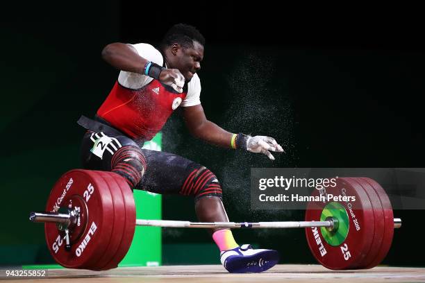Petit David Minkoumba of Cameroon drops the bar in the Men's 94kg final during Weightlifting on day four of the Gold Coast 2018 Commonwealth Games at...
