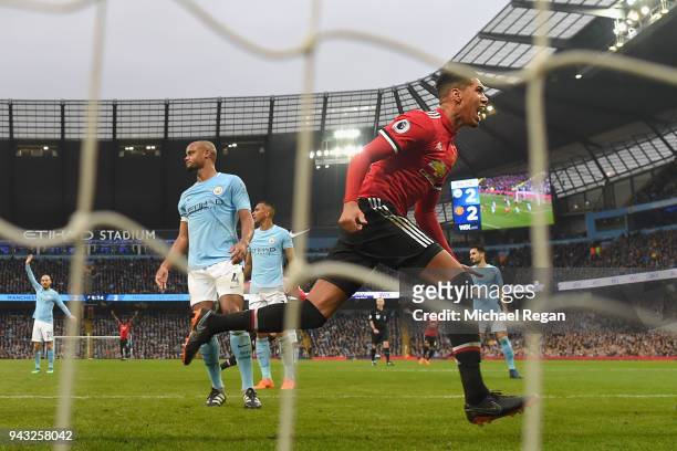 Chris Smalling of Manchester United celebrates scoring the winning goal to make it 3-2 as Vincent Kompany of Manchester City looks on during the...