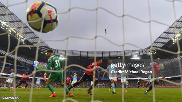 Chris Smalling of Manchester United celebrates scoring the winning goal to make it 3-2 as Vincent Kompany of Manchester City looks on during the...