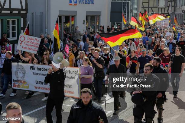 The protesters march with flags and banners through Kandel. Around 500 people from right-wing organisations protested in the city of Kandel in...