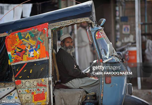 Auto Rickshaw Owner An auto-rickshaw driver waits for passengers in the eastern town of ...