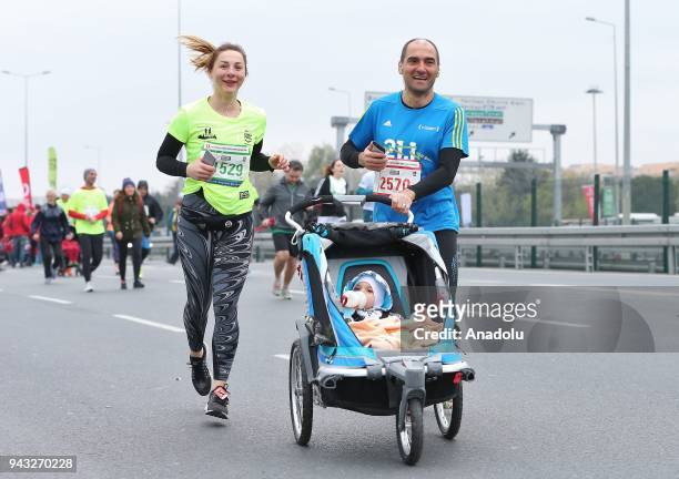 Couple participate in the competition with their baby in the 13th Vodafone Istanbul Half Marathon at Yenikapi Square in Istanbul, Turkey on April 08,...