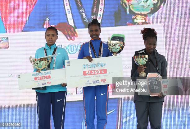 Women's 1st place winner Ethiopian Ababel Yeshaneh , 2nd place winner Ethiopian Roza Dereje and 3rd place winner Kenyan Diana Chemtai Kipyokei pose...