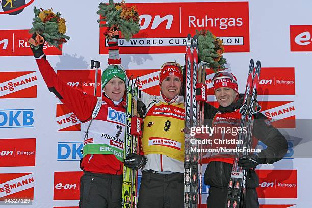 Simon Eder of Austria , Emil Hegle Svendsen of Norway and Ole Einar Bjoerndalen of Norway during the Flower Ceremony after the men's 12.5km pursuit...
