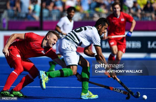 Ammad Shakeel Butt of Pakistan and Sam Ward of England fight for the ball during the men's field hockey match between Pakistan and England at the...