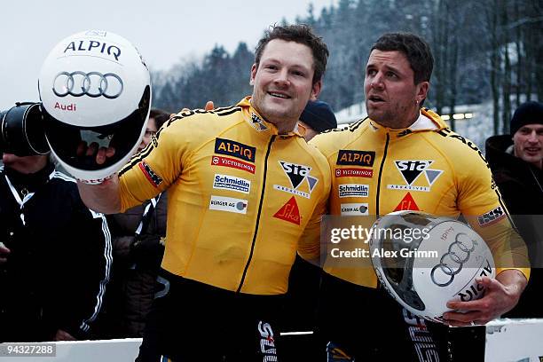 Pilot Beat Hefti and brakeman Thomas Lamparter of Switzerland celebrate winning the two-man bob competition during the FIBT Bob & Skeleton World Cup...