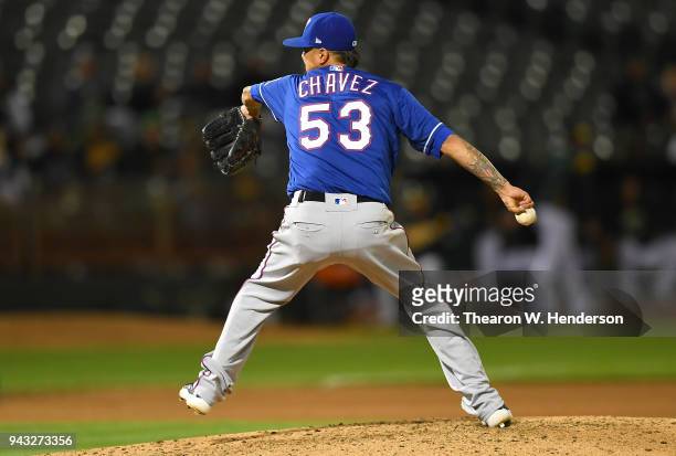 Jesse Chavez of the Texas Rangers pitches against the Oakland Athletics in the bottom of the seventh inning at the Oakland Alameda Coliseum on April...