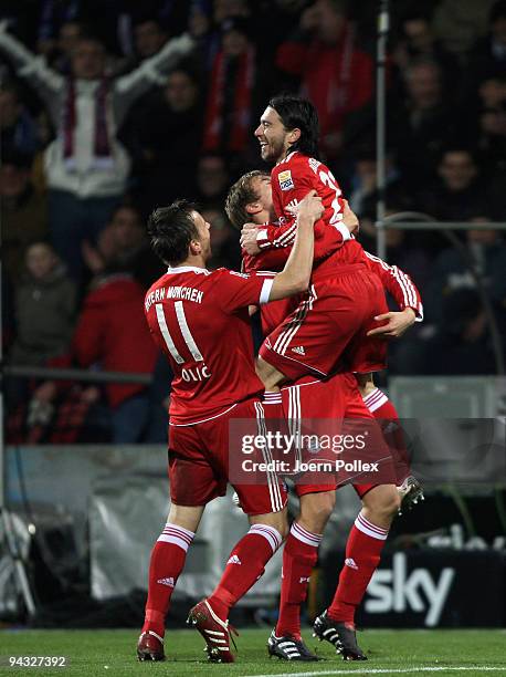 Danijel Pranjic of Bayern celebrates with his team mates Ivica Olic and Holger Badstuber after scoring his team's fifth goal during the Bundesliga...