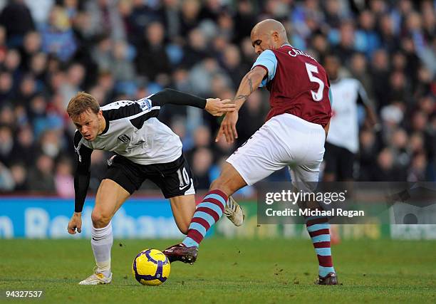 Erik Nevland of Fulham gets past Clarke Carlisle of Burnley during the Barclays Premier League match between Burnley and Fulham at Turf Moor on...