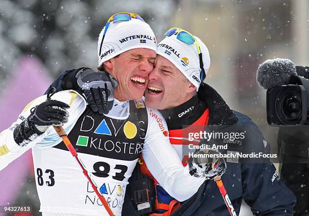 Marcus Hellner of Sweden celebrates his second place with his coach after the Men's 15 km Individual event in the FIS Cross Country World Cup on...