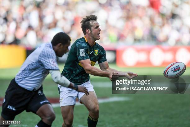 Heino Bezuidenhout of South Africa pases the ball against Fiji on the third day at the Hong Kong Sevens rugby tournament in Hong Kong on April 8,...