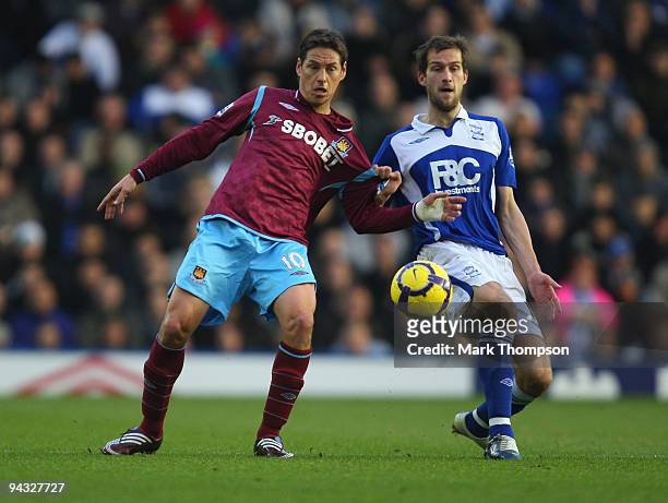 Guillermo Franco of West Ham United competes for the ball with Roger Johnson of Birmingham City during the Barclays Premier League match between...