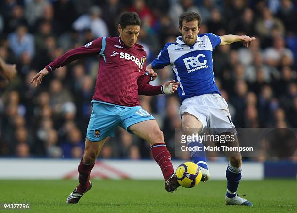 Guillermo Franco of West Ham United competes for the ball with Roger Johnson of Birmingham City during the Barclays Premier League match between...